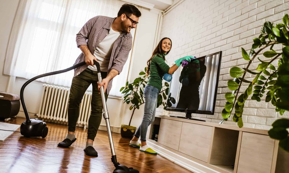 Couple cleaning their home